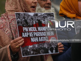 Members of the youth wing of the Indian National Congress party shout slogans and hold placards during a protest in Srinagar, Jammu and Kash...