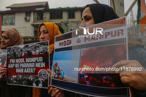 Members of the youth wing of the Indian National Congress party shout slogans and hold placards during a protest in Srinagar, Jammu and Kash...