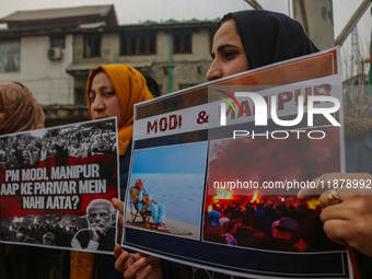 Members of the youth wing of the Indian National Congress party shout slogans and hold placards during a protest in Srinagar, Jammu and Kash...