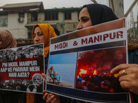 Members of the youth wing of the Indian National Congress party shout slogans and hold placards during a protest in Srinagar, Jammu and Kash...