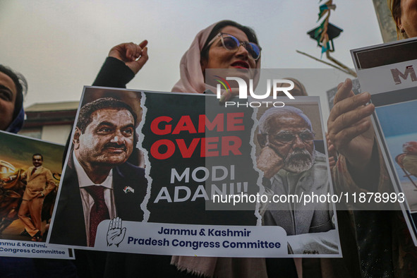 Members of the youth wing of the Indian National Congress party shout slogans and hold placards during a protest in Srinagar, Jammu and Kash...