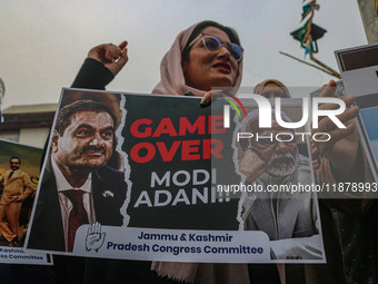 Members of the youth wing of the Indian National Congress party shout slogans and hold placards during a protest in Srinagar, Jammu and Kash...