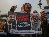 Members of the youth wing of the Indian National Congress party shout slogans and hold placards during a protest in Srinagar, Jammu and Kash...