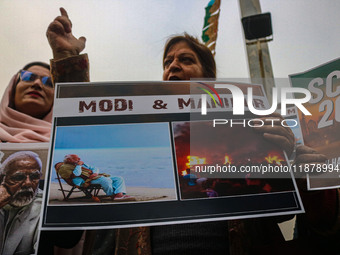 Members of the youth wing of the Indian National Congress party shout slogans and hold placards during a protest in Srinagar, Jammu and Kash...