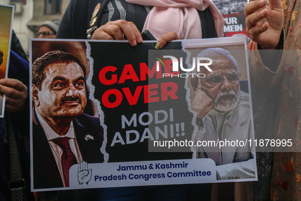 Members of the youth wing of the Indian National Congress party shout slogans and hold placards during a protest in Srinagar, Jammu and Kash...