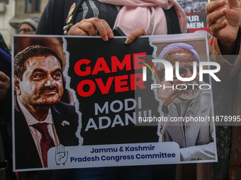 Members of the youth wing of the Indian National Congress party shout slogans and hold placards during a protest in Srinagar, Jammu and Kash...