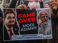 Members of the youth wing of the Indian National Congress party shout slogans and hold placards during a protest in Srinagar, Jammu and Kash...