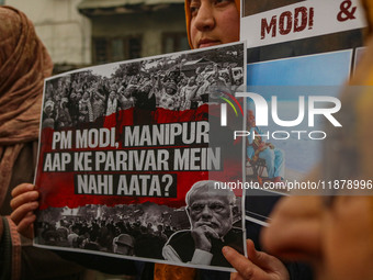 Members of the youth wing of the Indian National Congress party shout slogans and hold placards during a protest in Srinagar, Jammu and Kash...