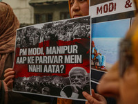 Members of the youth wing of the Indian National Congress party shout slogans and hold placards during a protest in Srinagar, Jammu and Kash...