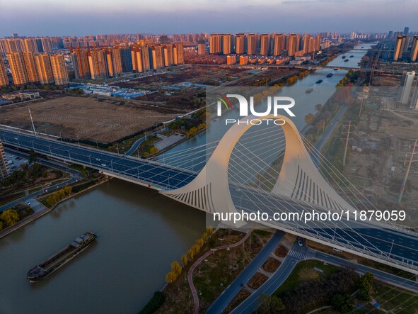 Transport ships sail on the Beijing-Hangzhou Grand Canal in Huai'an City, Jiangsu Province, China, on December 18, 2024. 