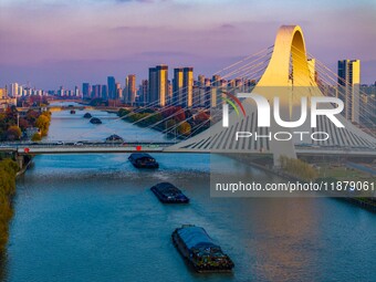 Transport ships sail on the Beijing-Hangzhou Grand Canal in Huai'an City, Jiangsu Province, China, on December 18, 2024. (