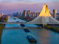 Transport ships sail on the Beijing-Hangzhou Grand Canal in Huai'an City, Jiangsu Province, China, on December 18, 2024. (