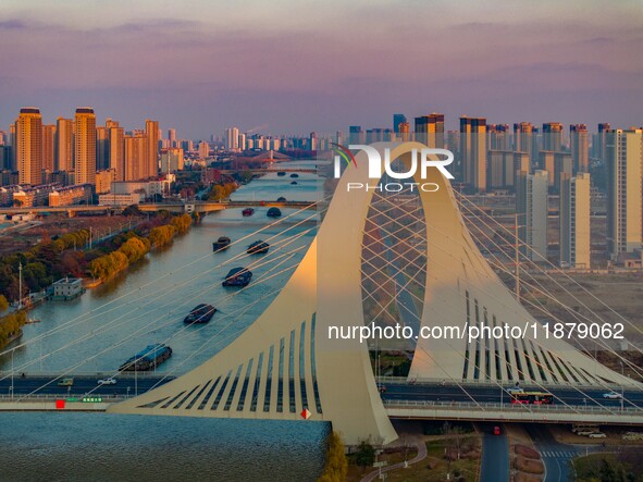 Transport ships sail on the Beijing-Hangzhou Grand Canal in Huai'an City, Jiangsu Province, China, on December 18, 2024. 