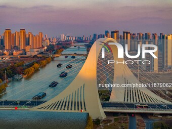 Transport ships sail on the Beijing-Hangzhou Grand Canal in Huai'an City, Jiangsu Province, China, on December 18, 2024. (