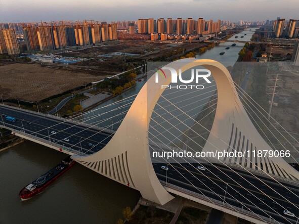 Transport ships sail on the Beijing-Hangzhou Grand Canal in Huai'an City, Jiangsu Province, China, on December 18, 2024. 