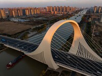 Transport ships sail on the Beijing-Hangzhou Grand Canal in Huai'an City, Jiangsu Province, China, on December 18, 2024. (