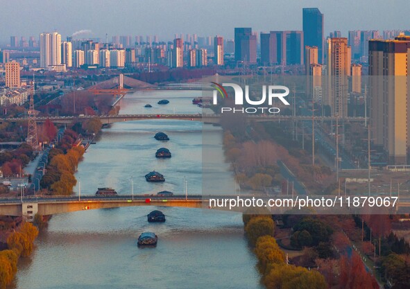 Transport ships sail on the Beijing-Hangzhou Grand Canal in Huai'an City, Jiangsu Province, China, on December 18, 2024. 