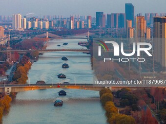 Transport ships sail on the Beijing-Hangzhou Grand Canal in Huai'an City, Jiangsu Province, China, on December 18, 2024. (