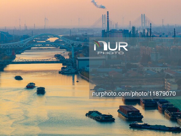 Transport ships sail on the Beijing-Hangzhou Grand Canal in Huai'an City, Jiangsu Province, China, on December 18, 2024. 