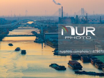 Transport ships sail on the Beijing-Hangzhou Grand Canal in Huai'an City, Jiangsu Province, China, on December 18, 2024. (