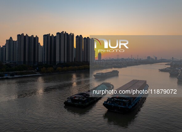 Transport ships sail on the Beijing-Hangzhou Grand Canal in Huai'an City, Jiangsu Province, China, on December 18, 2024. 