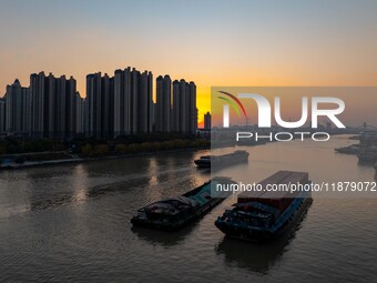 Transport ships sail on the Beijing-Hangzhou Grand Canal in Huai'an City, Jiangsu Province, China, on December 18, 2024. (