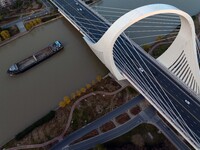 Transport ships sail on the Beijing-Hangzhou Grand Canal in Huai'an City, Jiangsu Province, China, on December 18, 2024. (