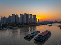 Transport ships sail on the Beijing-Hangzhou Grand Canal in Huai'an City, Jiangsu Province, China, on December 18, 2024. (