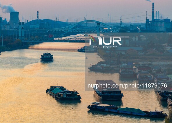 Transport ships sail on the Beijing-Hangzhou Grand Canal in Huai'an City, Jiangsu Province, China, on December 18, 2024. 