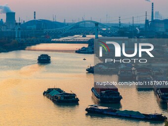 Transport ships sail on the Beijing-Hangzhou Grand Canal in Huai'an City, Jiangsu Province, China, on December 18, 2024. (