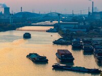 Transport ships sail on the Beijing-Hangzhou Grand Canal in Huai'an City, Jiangsu Province, China, on December 18, 2024. (