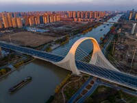 Transport ships sail on the Beijing-Hangzhou Grand Canal in Huai'an City, Jiangsu Province, China, on December 18, 2024. (