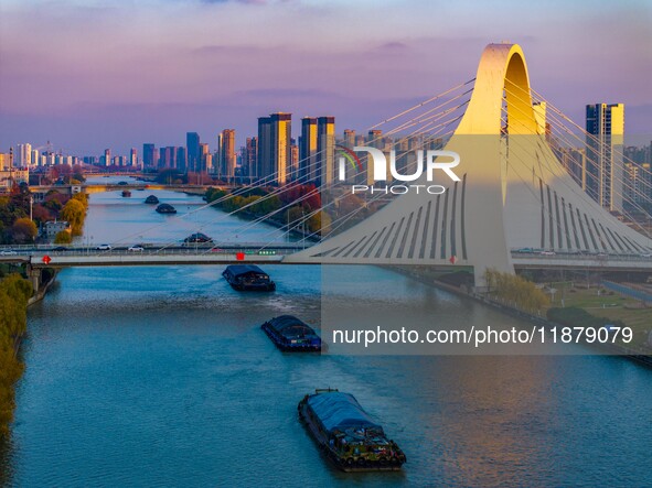 Transport ships sail on the Beijing-Hangzhou Grand Canal in Huai'an City, Jiangsu Province, China, on December 18, 2024. 