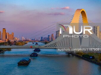 Transport ships sail on the Beijing-Hangzhou Grand Canal in Huai'an City, Jiangsu Province, China, on December 18, 2024. (