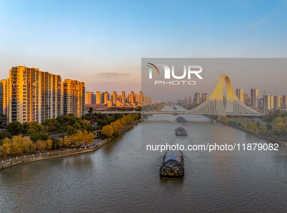 Transport ships sail on the Beijing-Hangzhou Grand Canal in Huai'an City, Jiangsu Province, China, on December 18, 2024. 