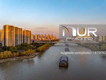 Transport ships sail on the Beijing-Hangzhou Grand Canal in Huai'an City, Jiangsu Province, China, on December 18, 2024. (