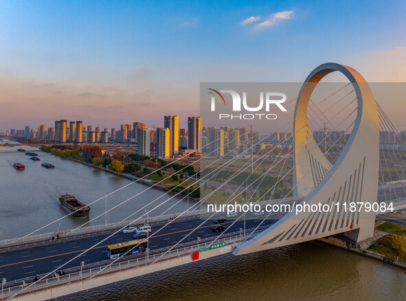 Transport ships sail on the Beijing-Hangzhou Grand Canal in Huai'an City, Jiangsu Province, China, on December 18, 2024. 