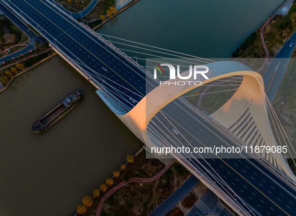 Transport ships sail on the Beijing-Hangzhou Grand Canal in Huai'an City, Jiangsu Province, China, on December 18, 2024. 