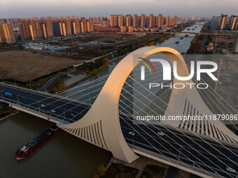 Transport ships sail on the Beijing-Hangzhou Grand Canal in Huai'an City, Jiangsu Province, China, on December 18, 2024. (