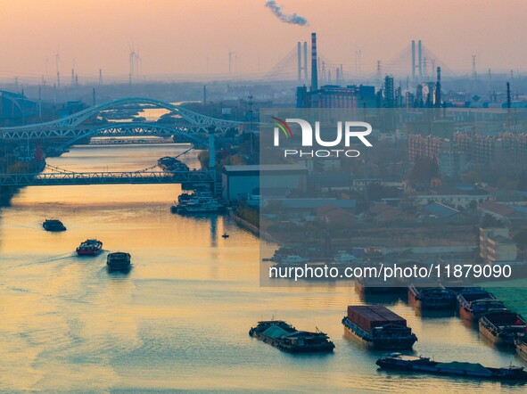 Transport ships sail on the Beijing-Hangzhou Grand Canal in Huai'an City, Jiangsu Province, China, on December 18, 2024. 