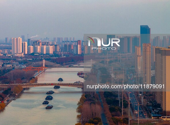 Transport ships sail on the Beijing-Hangzhou Grand Canal in Huai'an City, Jiangsu Province, China, on December 18, 2024. 