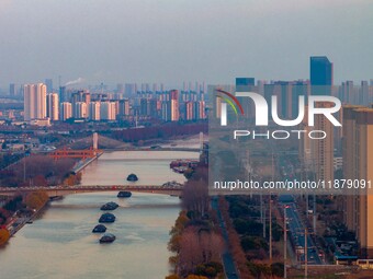 Transport ships sail on the Beijing-Hangzhou Grand Canal in Huai'an City, Jiangsu Province, China, on December 18, 2024. (