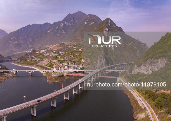 Vehicles drive on the Guzhao water highway in Xingshan County, Yichang City, Central China's Hubei Province, on December 18, 2024. 