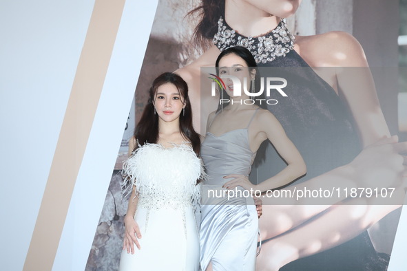 Dolly, a member of the girl group G.O.F., and actress Nikita attend the opening ceremony of the dress brand in Taipei, Taiwan Province, Chin...