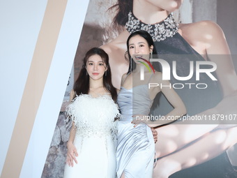 Dolly, a member of the girl group G.O.F., and actress Nikita attend the opening ceremony of the dress brand in Taipei, Taiwan Province, Chin...