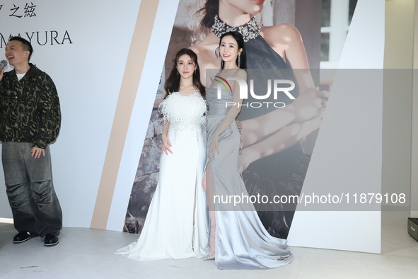 Dolly, a member of the girl group G.O.F., and actress Nikita attend the opening ceremony of the dress brand in Taipei, Taiwan Province, Chin...