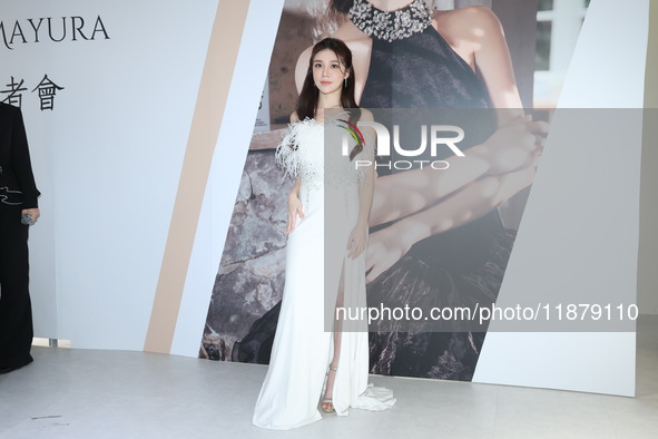 Dolly, a member of the girl group G.O.F., attends the opening ceremony of the dress brand in Taipei, Taiwan, on December 18, 2024. 