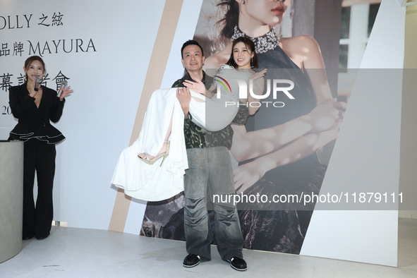 Dolly, a member of the girl group G.O.F., and Taiwanese singer Jason attend the opening ceremony of the dress brand in Taipei, Taiwan, on De...