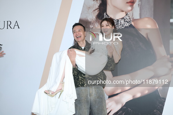 Dolly, a member of the girl group G.O.F., and Taiwanese singer Jason attend the opening ceremony of the dress brand in Taipei, Taiwan, on De...