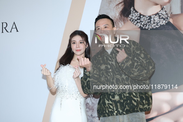 Dolly, a member of the girl group G.O.F., and Taiwanese singer Jason attend the opening ceremony of the dress brand in Taipei, Taiwan, on De...